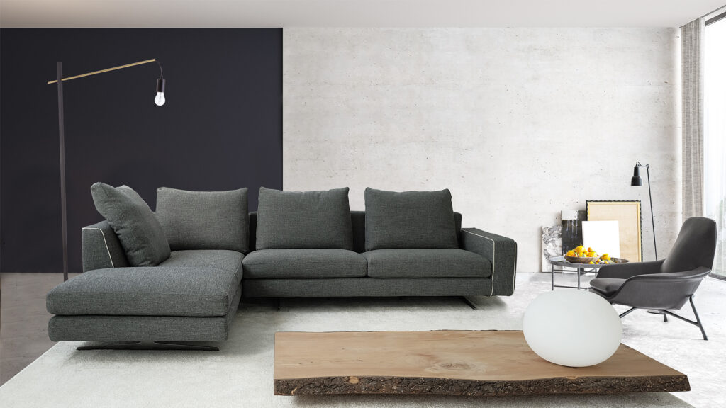 Modern interior design of a living room in an apartment, house, office, comfortable sofa, bright modern interior details and light from the window on the background of the Disiner wall.